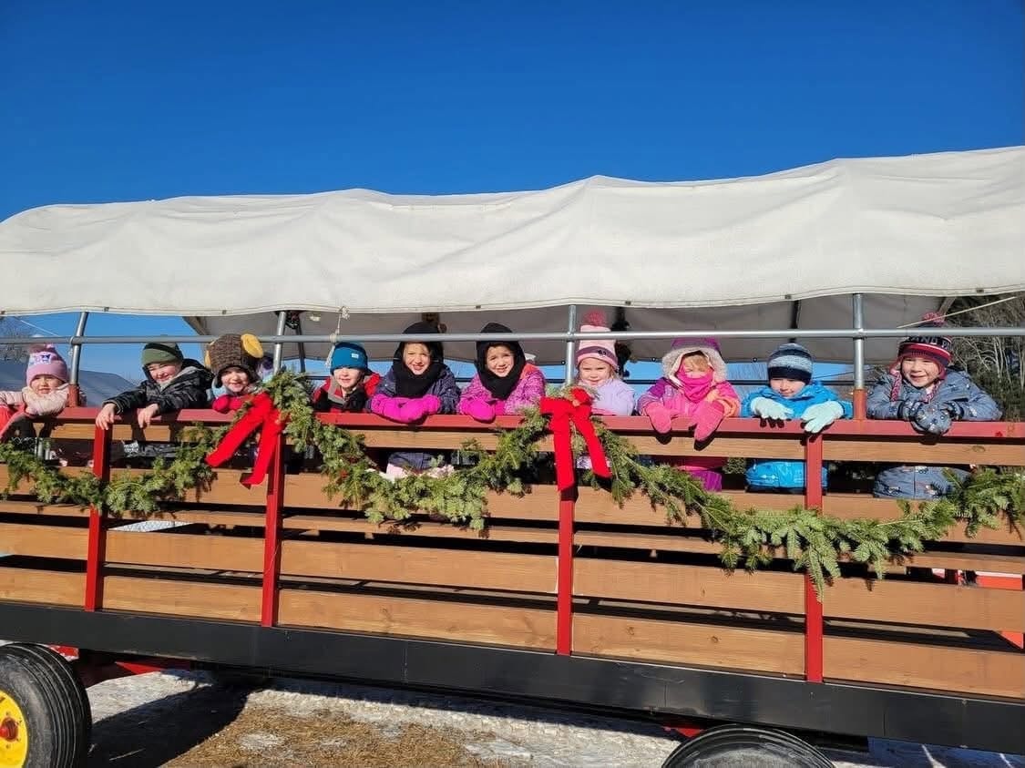 Children on a decorated hayride wagon at Noel's Tree Farm
