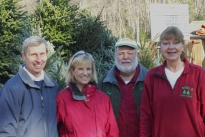 Four people smiling outdoors together