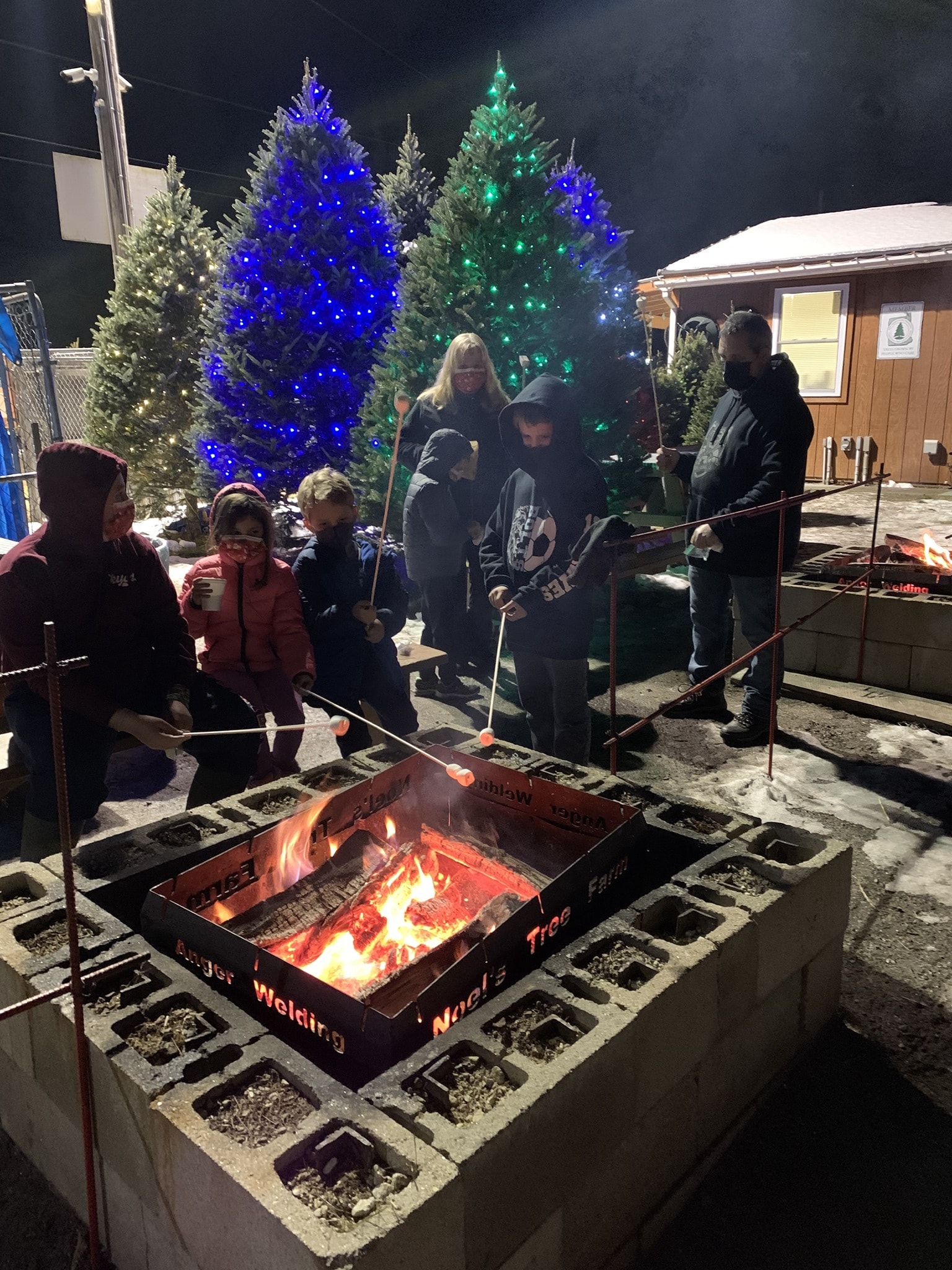 People gathered around bonfire holiday celebration