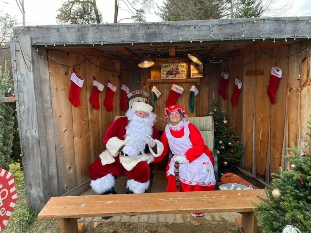 Santa and Mrs. Claus in their decorated holiday booth at Noel's Tree Farm