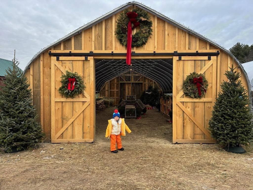 Child standing in front of decorated barn