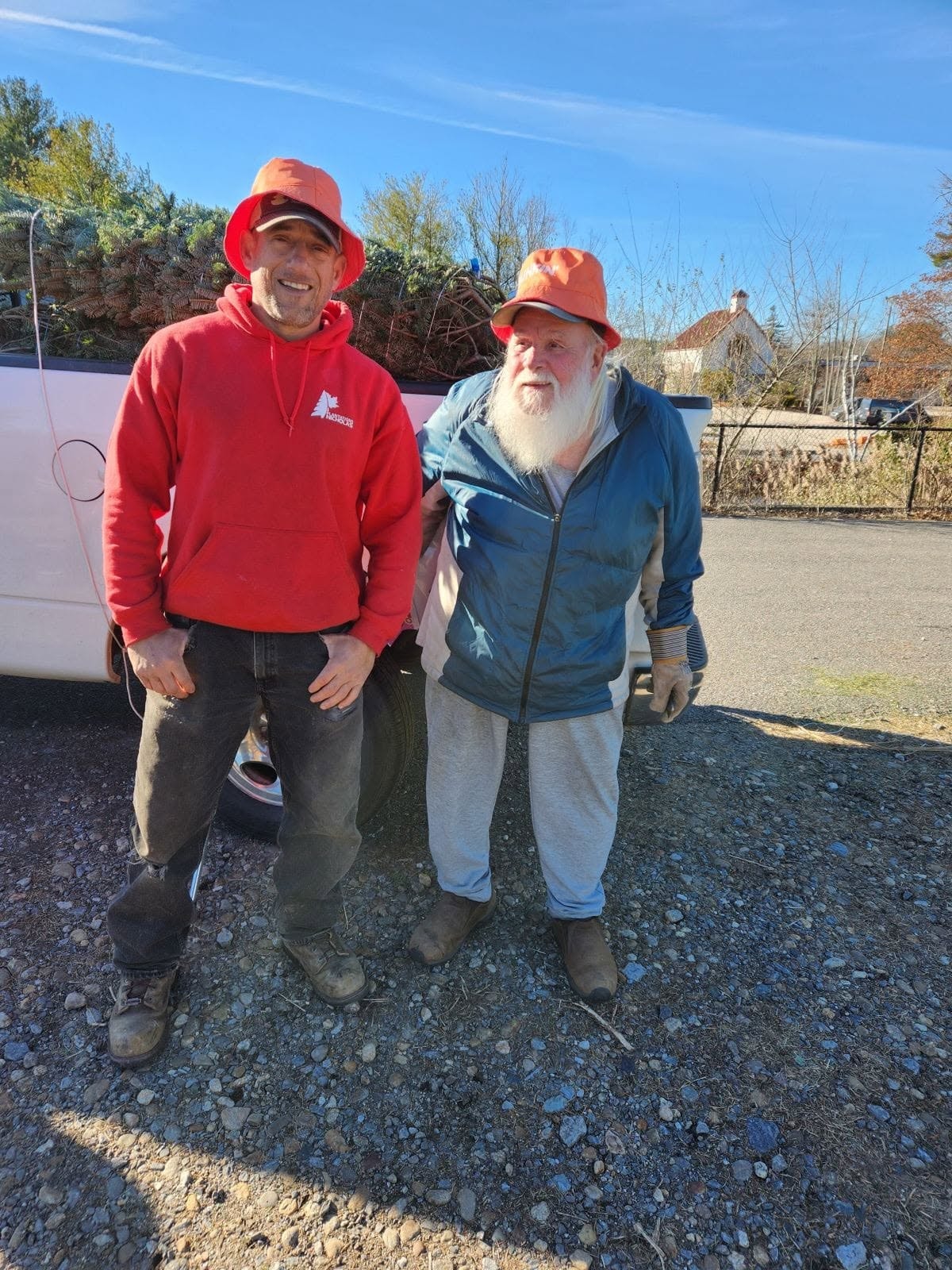 Two Noel's Tree Farm team members smiling outdoors